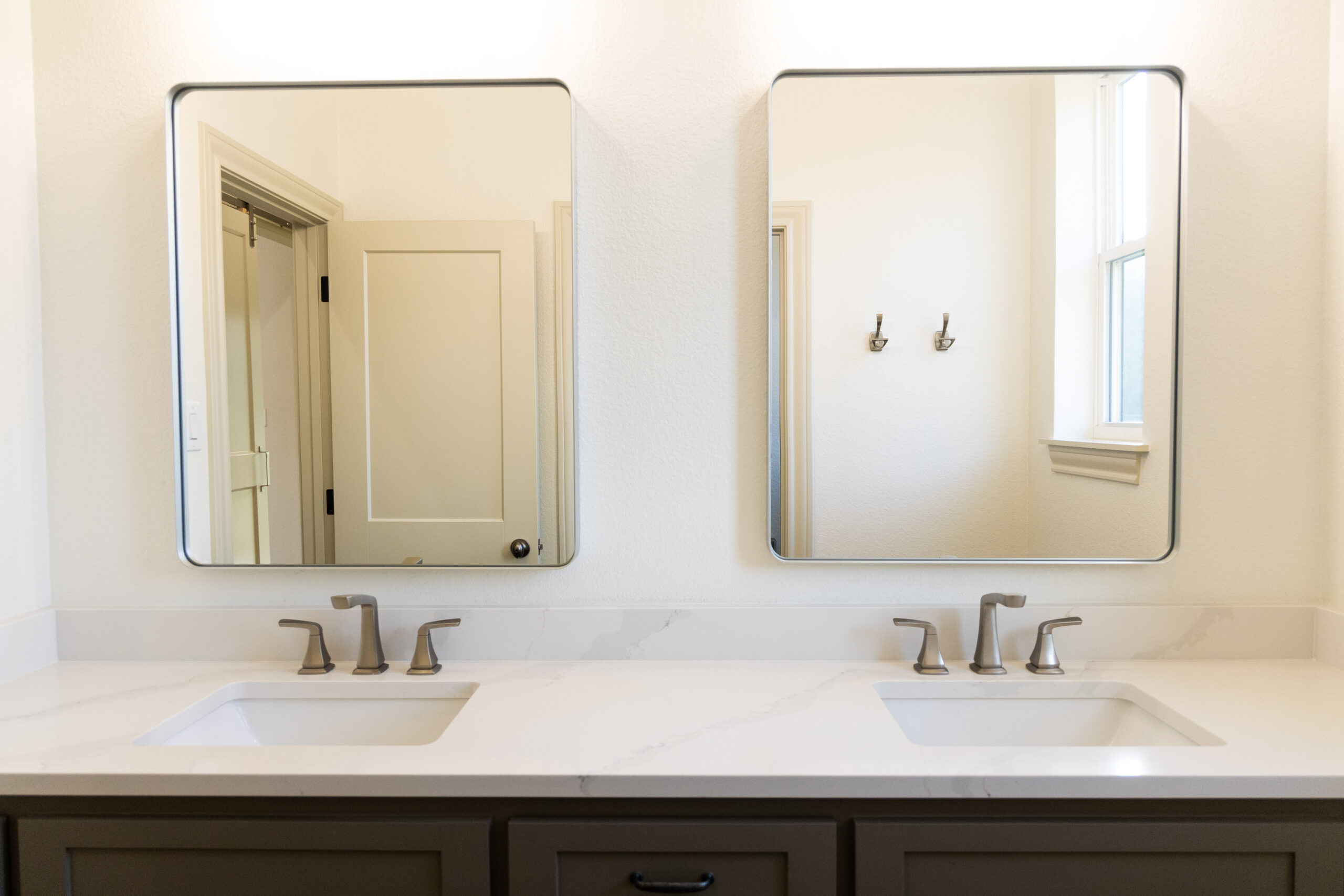 Modern bathroom with dual sinks and mirrors, showcasing accessible bathroom solutions by Waco Bathroom Remodel near me