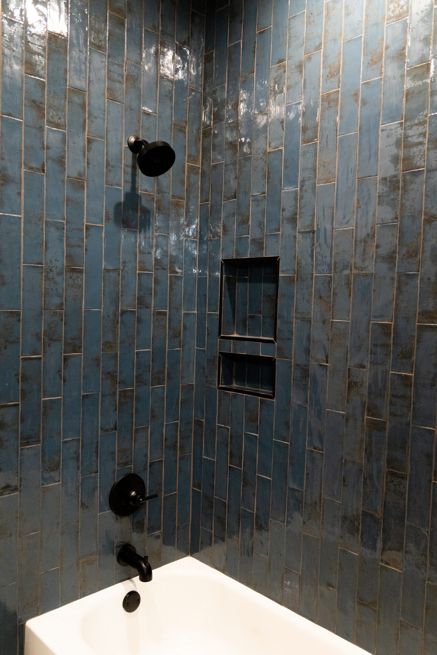 Stylish custom tile work in a bathroom near Waco, featuring blue tiles and a sleek shower design by Waco Bathroom Remodel