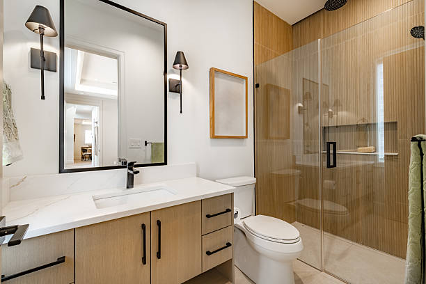 Professional remodeler renovating bathroom space to create updated stylish design.
