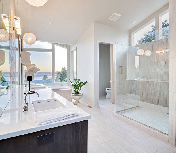 Bathroom remodeling crew performing precise plumbing and fixture installations